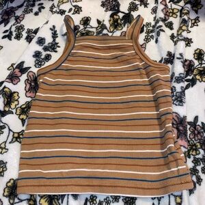 This shirt is for 3/4 year olds. It’s a brown with white blue and maroon stripes